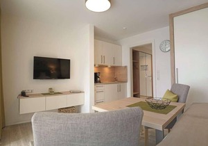 Vacation home with box-spring bed and south-facing balcony