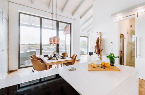 Waase Apartment | FISCHER:IN Vacation Rental in Ummanz. Panoramic sauna with a stunning view of the water. Spacious sun deck for relaxing vacation moments. The ultimate in sleeping comfort with box-spring beds. Insect Screen