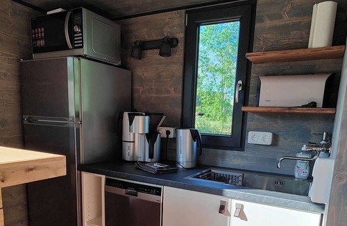 Buhlau House | Spectacular tiny house in a pond with terrace and fireplace