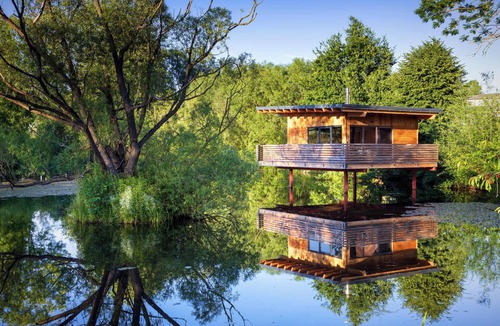 Buhlau House | Spectacular tiny house in a pond with terrace and fireplace