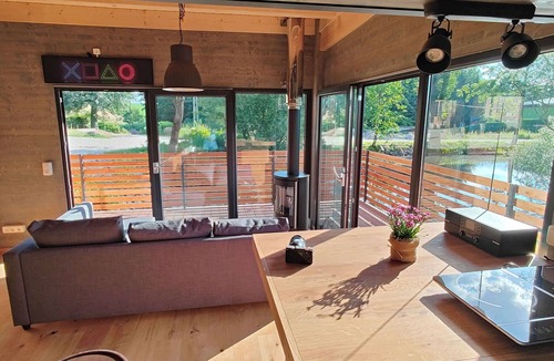 Buhlau House | Spectacular tiny house in a pond with terrace and fireplace