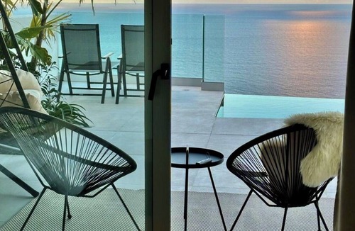 Las Cuevas Ski Chalet | White House Relaxation, Views, and an Infinity Pool