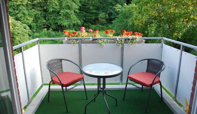 grand 2-room apartment (70m²) with balcony, central but located in green landsca
