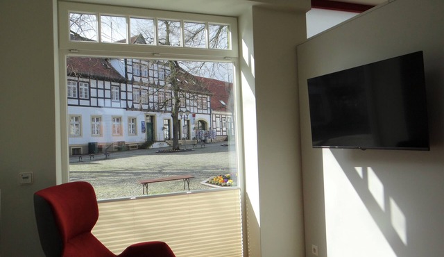 Modern apartment with a fireplace in a listed half-timbered house on the market square