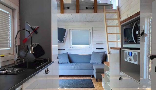 Tiny House by a swimming pond with terrace & fireplace – Last Minute